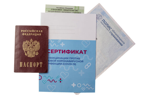 The Russian passport, insurance certificate, insurance policy and certificate of vaccination are isolated on a white background