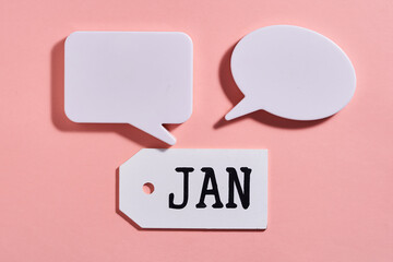 wood tag with text Jan and speech bubble for copy space