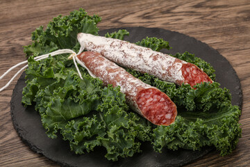 Spanish Fuet sausage with salad leaves