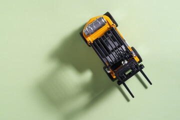 top view of toy forklift on green background