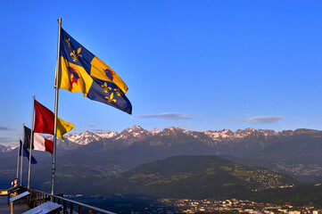 Grenoble flag and aerial city view with the Alps on the background,  France