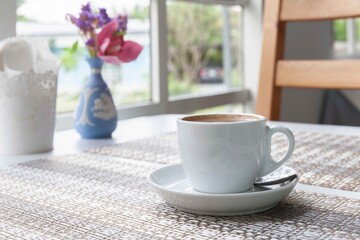 A hot Americano coffee cup on the table inside a modern cafe