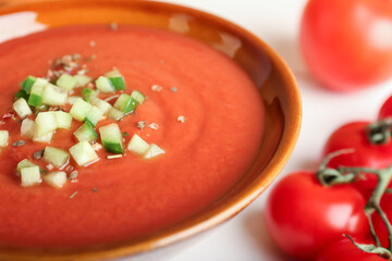 Bowl with tasty gazpacho on light background, closeup