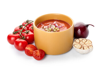 Bowl with tasty gazpacho and vegetables on white background