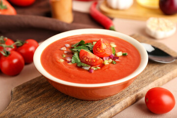 Bowl with tasty gazpacho on color background, closeup