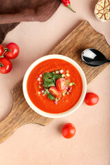 Bowl with tasty gazpacho on color background