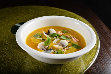 asian premium banquet menu double boiled seafood with shell yellow stock pumpkin thick soup on gold background dining table