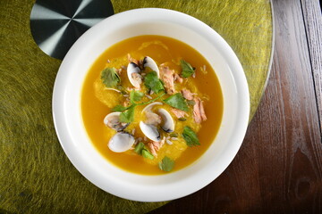 asian premium banquet menu double boiled seafood with shell yellow stock pumpkin thick soup on gold background dining table