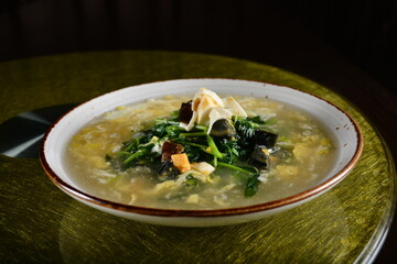 asian premium banquet menu stir fried water spinach vegetables with 3 type of golden eggs in thick gravy sauce on gold background dining table