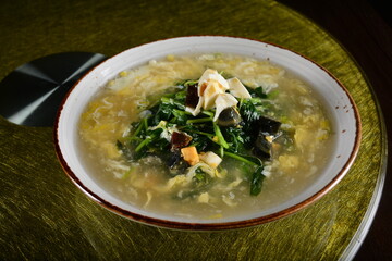 asian premium banquet menu stir fried water spinach vegetables with 3 type of golden eggs in thick gravy sauce on gold background dining table