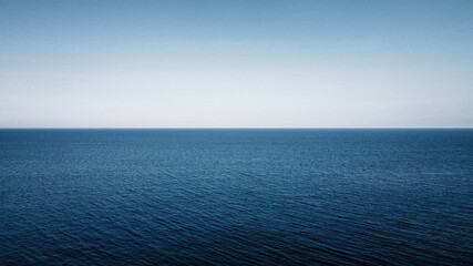 Blue Ocean with the sky on blackground, split image betwenn the sea and sky 