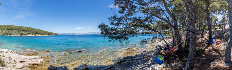 panoramic view of woman in hammock on the island Solta, Croatia