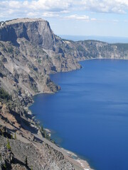 the steep cliffs of Crater Lake national park and deep blue lake along the rim drive, oregon