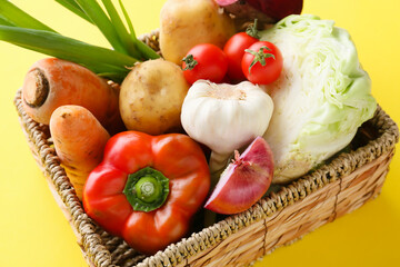 Wicker basket with ingredients for preparing borscht on color background