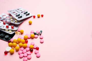Fototapeta na wymiar pill packaging multicolored medicines pharmaceutical health pink background