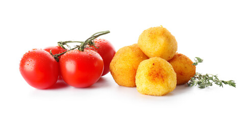 Fried potato balls and tomatoes on white background