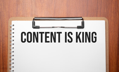 Content is King text on white paper on the wood table