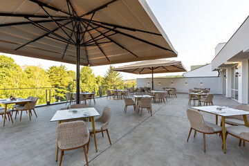 Empty terrace hotel restaurant with sun shades