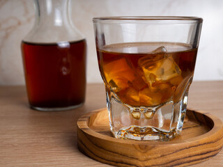 A cup of iced coffee on a wooden table
