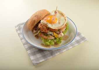 chef handmade giant deep fried crispy chicken with fried egg and vegetables cheesy burger in japanese sesame sauce western fast food halal menu