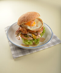 chef handmade giant deep fried crispy chicken with fried egg and vegetables cheesy burger in japanese sesame sauce western fast food halal menu
