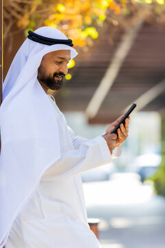Middle Eastern Arab Emirati Vlogger holding mobile phone