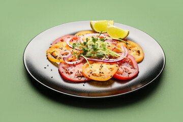 Plate with tasty tomato carpaccio on color background