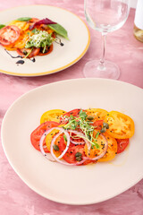 Plates with tasty tomato carpaccio on color background