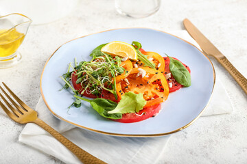Plate with tasty tomato carpaccio on light background