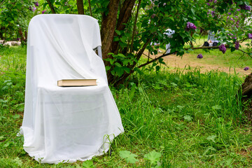 Photo of a white chair in the garden for relaxation