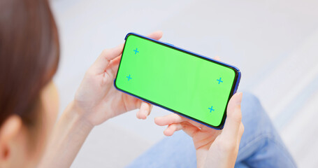 woman with green screen smartphone