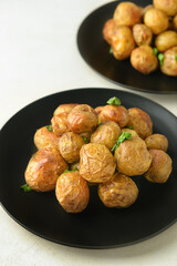 Plates with tasty baked potato on light background