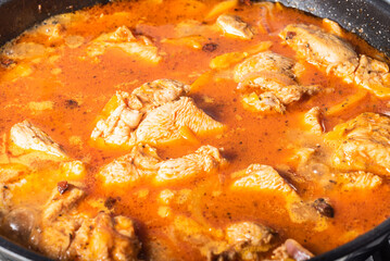 Chicken breast curry is cooked in a pan. Chicken in sauce, close-up.