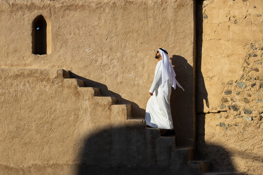 Middle Eastern Arab Emirati man exploring Fujairah Fort in the United Arab Emirates