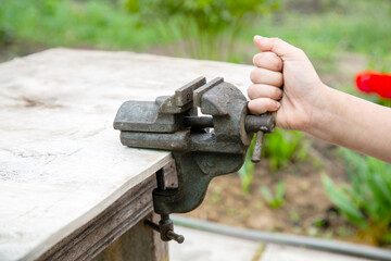 vintage locksmith vice on, hand rotates the handle