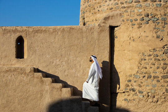 Middle Eastern Arab Emirati man exploring Fujairah Fort in the United Arab Emirates