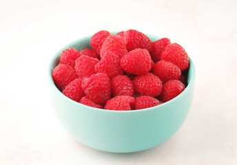 A bowl with ripe bright raspberries