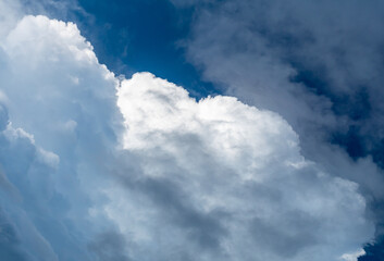 Naklejka na ściany i meble White and grey clouds veiling the blue sky