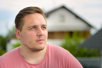 Close up on the face of a thoughtful young man in his twenties