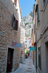 narrow street with stone buildings, Omis, Croatia