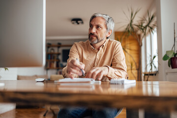 Adult man, attending a business meeting.