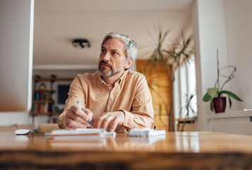 Adult man, organizing his busy day at work.