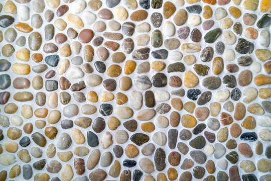 River stone wall. Colorful little pabble rock on the wall background