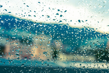 Rain drops on window glasses surface with sunset. drops on glass spray on window background for dark text view selective focus