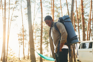 African american man is traveling alone in the forest at daytime at summer