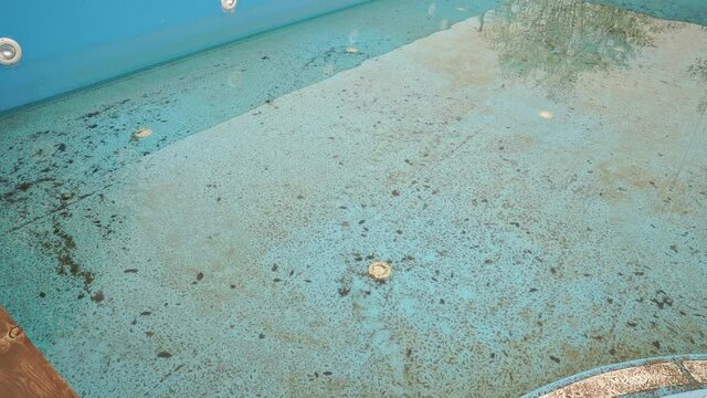 abandoned and dirty pool. cleaning the pools before the summer season. cleaning service.