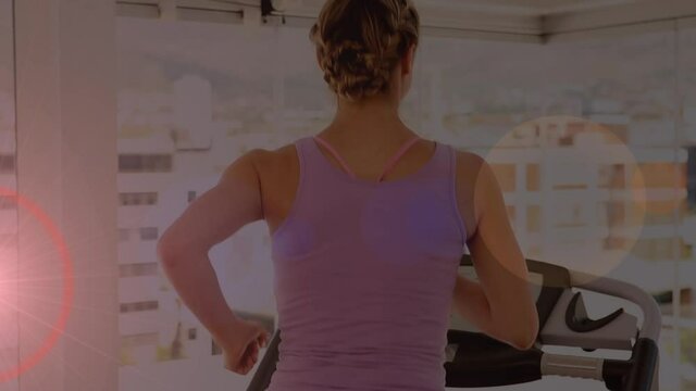 Animation of glowing light over woman running on treadmill