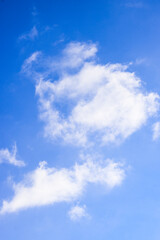 Naklejka na ściany i meble Blue sky with shiny white clouds