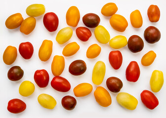 Cherry tomatoes of different colors isolated on the white background, yellow, orange, red, green