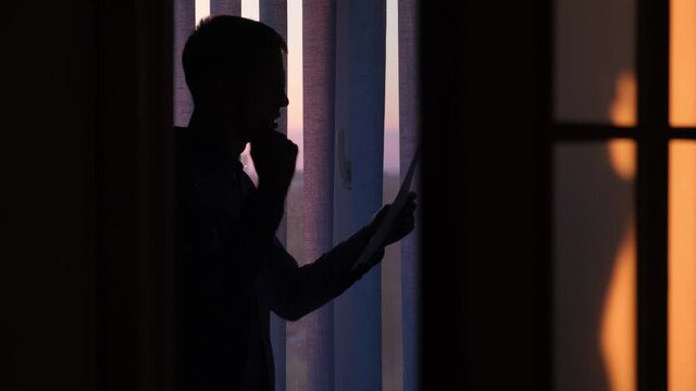 Actor emotionally practicing a role or script in a dark room